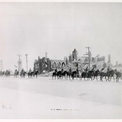 [Group of men riding on horses along Van Ness Avenue]