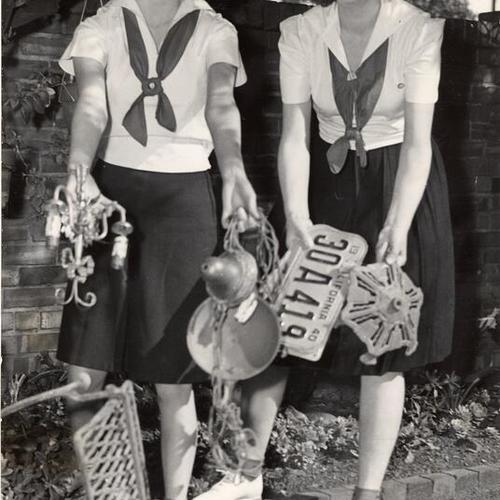 [San Francisco Camp Fire Girls Carol Wallace and Carol Filene show some of the scrap metal they and other members have collected as their current war project]