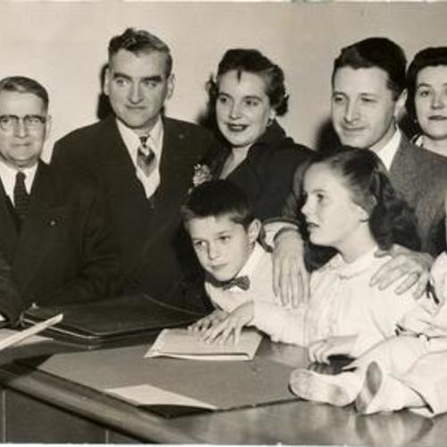 [Five Assemblymen, with their families in tow, filing for re-election at the Registrars office]