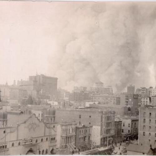 [View of Alhambra Theater, with fire burning in background]