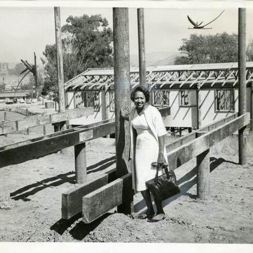 [Mrs. Moses E. Beard by housing construction site]
