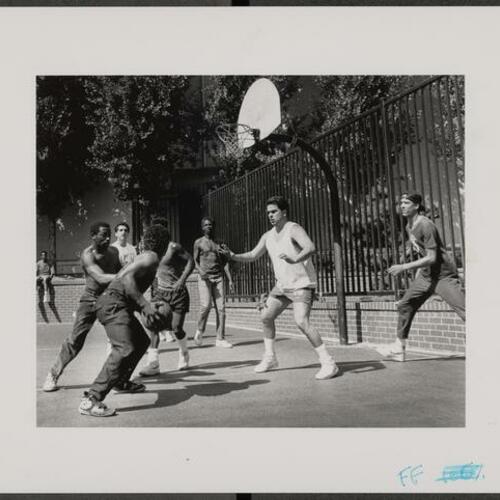 Tenderloin residents playing basketball at only neighborhood basketball half court at Boeddeker Park