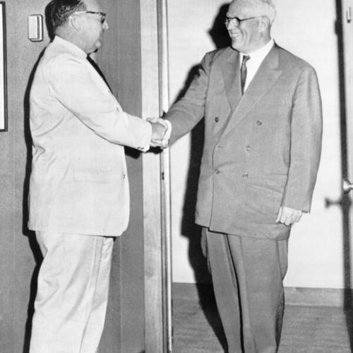 [U.S. Supreme Court Chief Justice Earl Warren, right, steps into the California governors office he occupied between 1942 and 1953 to be greeted by its current occupant, Edmund G. Brown]