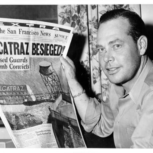 [Marine C. L. Buckner reading a newspaper article about the "Battle of Alcatraz" in which he took part]