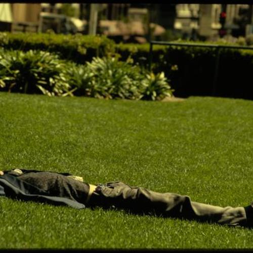 Person sleeping on lawn in Union Square