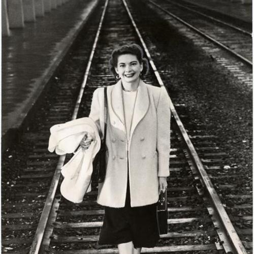 [Mrs. J. D. Page standing on Southern Pacific railroad tracks during strike]