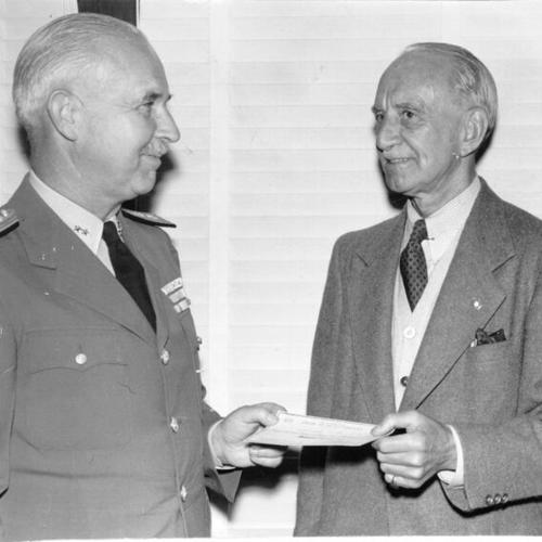 [Marshall Hale and Rear Admiral Murrey L. Royan holding a check]