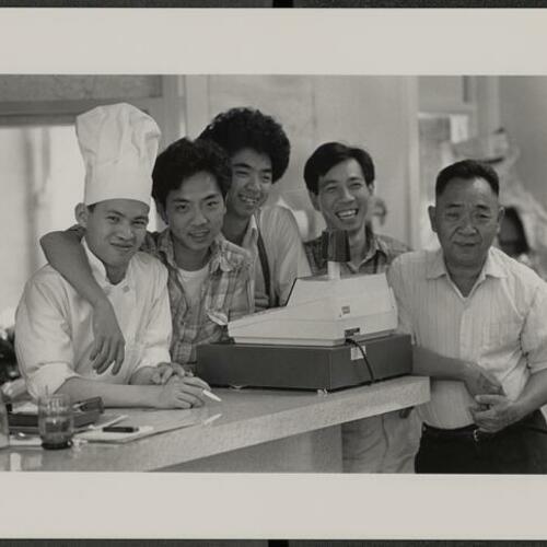 Brothers Sam, Tom, John, and Wilson Ho pictured with their father "Big Howard" in their family-owned Five Brothers Italian restaurant