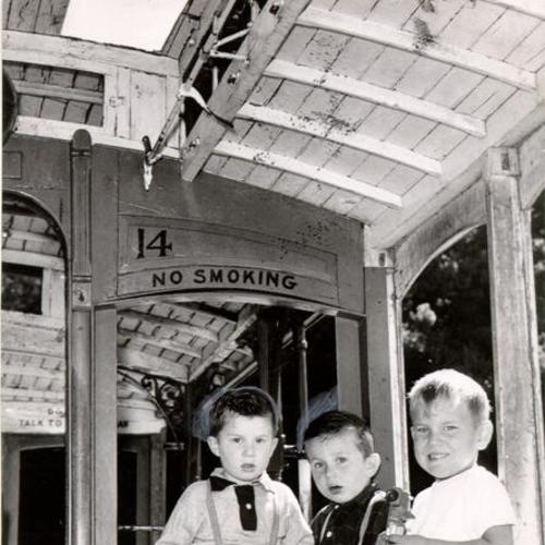 [Bobby and Albert Margolis and Drake Geta playing on a cable car at children's playground in Golden Gate Park]