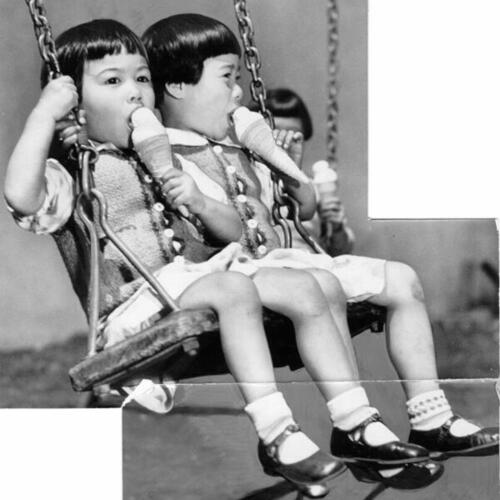 [Two Chinese girls playing on a swing and eating ice cream]