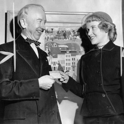 [Thomas A. Brooks, receives his S. F. Museum of Art membership card from Mrs. Edmund MacDonald]