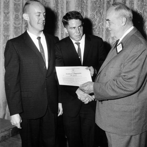 [Lowell High School student Tom Darcey being congratulated by Raymond Kohtz and Carl F. Wente for winning a journalism contest]