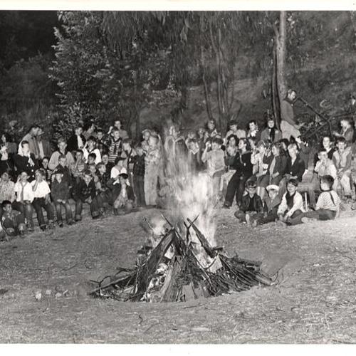 [Children sitting around camp fire at Glen Park]
