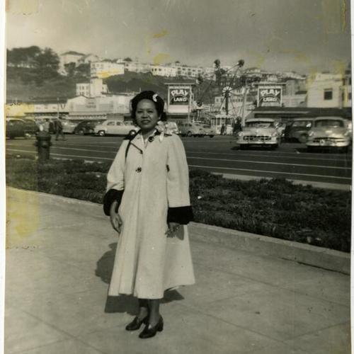 [Joan May's mother as a young graduate student standing in front of Playland, Ocean Beach]