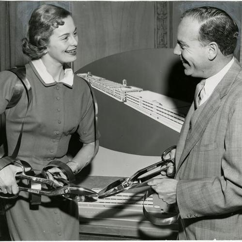 [Jeanne Kessey and R. C. Stolk rehearsing for their parts in the dedication ceremony for the American Can Company's expanded manufacturing plant]