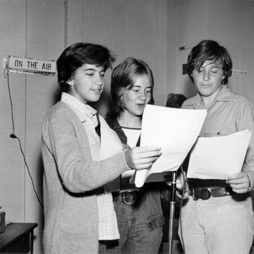 [Three students participating in a radio broadcast at Presidio Junior High School]