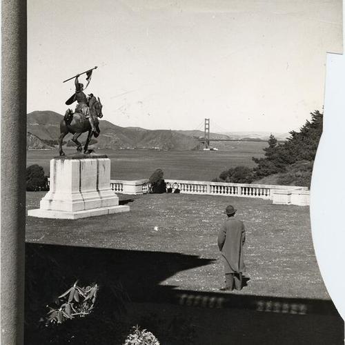 [Statue of warrior on horse in front of the Palace of the Legion of Honor, with view of Golden Gate Bridge in background]