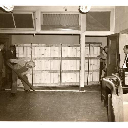 [Workmen with the new material for the Communications Room upgrading in Old Hall of Justice]