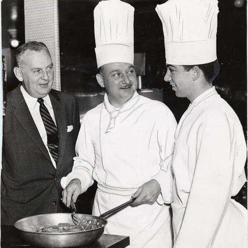 [City College of San Francisco hotel and restaurant student Robert Boyle being instructed by St. Francis Hotel executive chef Paul H. Debes]