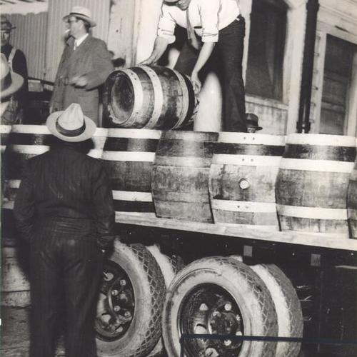 [Kegs of beer being loaded for delivery at Acme Brewery]