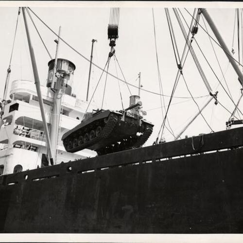 [Tank being lifted onto a ship at the San Francisco waterfront]
