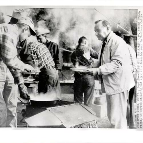 [Governor Edmund G. Brown receiving breakfast during his annual horseback inspection trip]