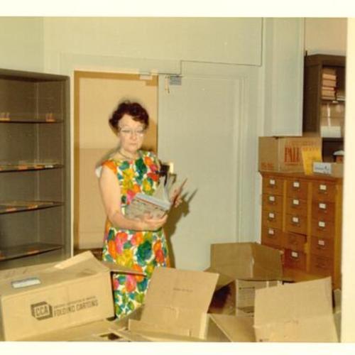 [Staff examining receiving inventory in the Order Department at Main Library]