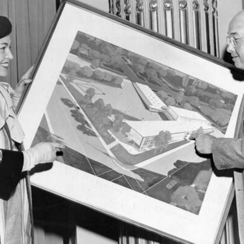 [Rosemary Lick Regardie and Harry Hilp holding architect's sketch of new school]
