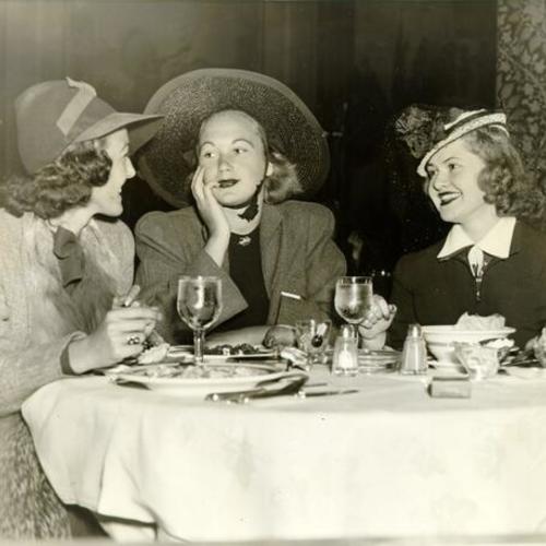 [Miss Patricia McLean, Mrs. Benjamin Reed and Miss Jane Spieker eating lunch at the St. Francis Hotel]