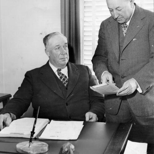 [William W. felt, secretary of Golden Gate Bridge and Highway District, getting original Assembly Bill 6 from Nathan F. Coombs, Napa County Bridge director]