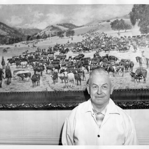 [Unidentified man standing in front of a painting in Visitacion Valley]