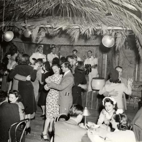 [People dancing inside the Tahitian Hut nightclub]