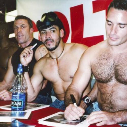 [Men autographing their photos at a porn shop on Market Street]