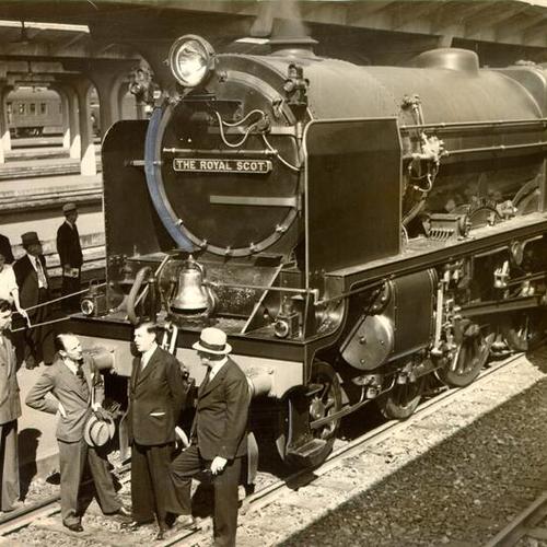 [Four men standing in front of the Royal Scot locomotive]