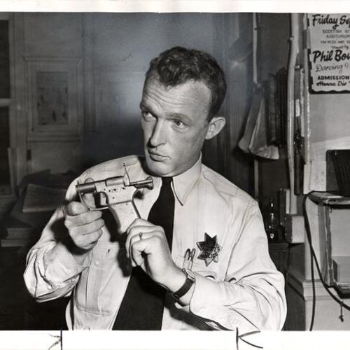 [Officer William McDonald with home made .45 gun]