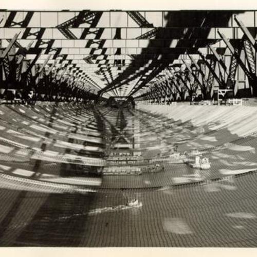 [View of underside of the Golden Gate Bridge while it was under construction, showing safety net]