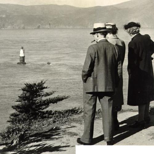 [Three pedestrians overlooking the bay at Lands End]