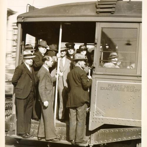[Passengers on a streetcar at Haight and Market streets]