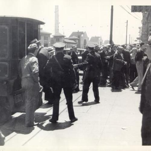 [Police officers controlling crowds on waterfront during General Strike]