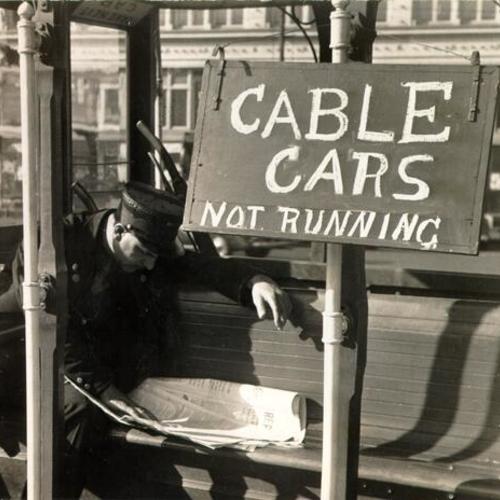 [Cable car gripman taking it easy at Ferry Building when his car was stalled]