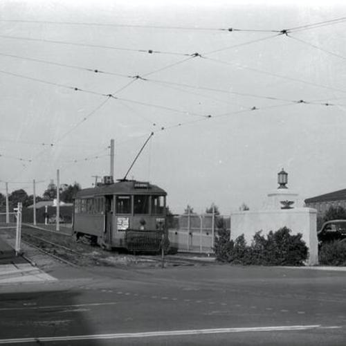 [Bay street and Van Ness avenue gate of Fort Mason showing outbound Muni "H" car 159 entering private right of way]