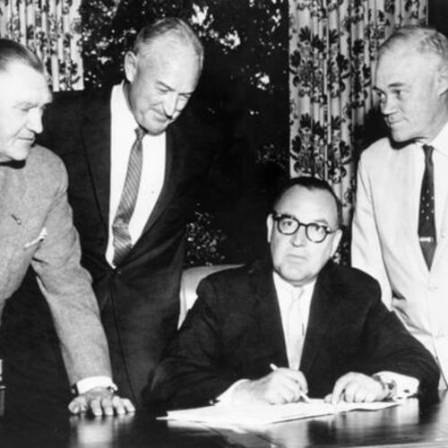[Governor Edmund G. Brown, seated, signs into law bill allocating $750,000 annually in gas tax for small craft harbor development]