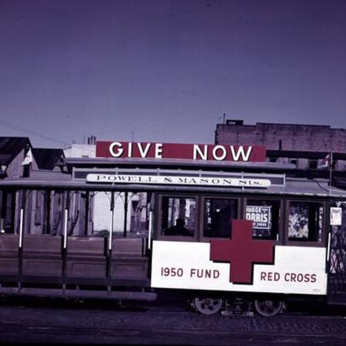 [Muni Powell & Mason line car 509 at Bay and Taylor streets decorated for 1950 Red Cross Fund Drive]