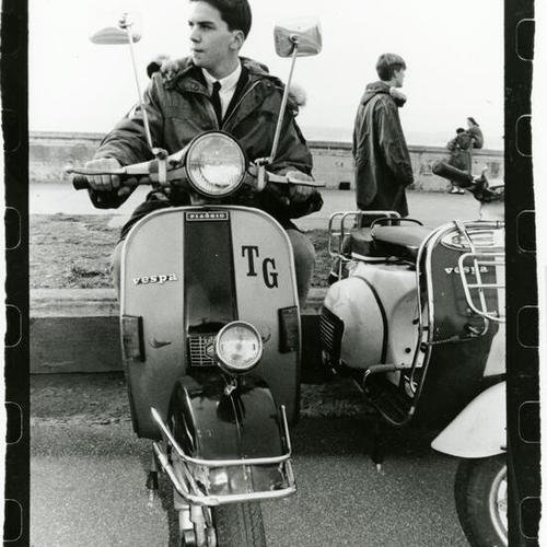 [Tom on a scooter at Ocean Beach across from Beach Chalet]