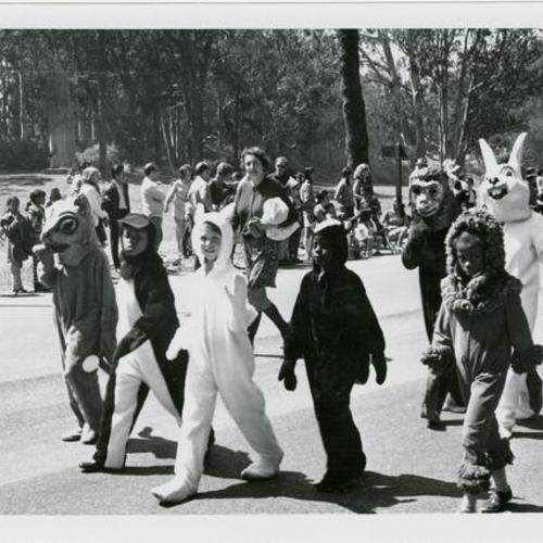 [Children dressed in animal costumes marching in the Golden Gate Park Centennial Parade]