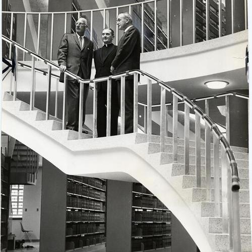 [Architect Milton Pflueger and University of San Francisco president Reverend John F. X. Connolly and Dean Francis R. Walsh inspecting the newly built Kendrick Hall]