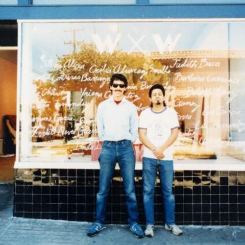 [Mike and Sal in front of a window display at La Galeria de la Raza]