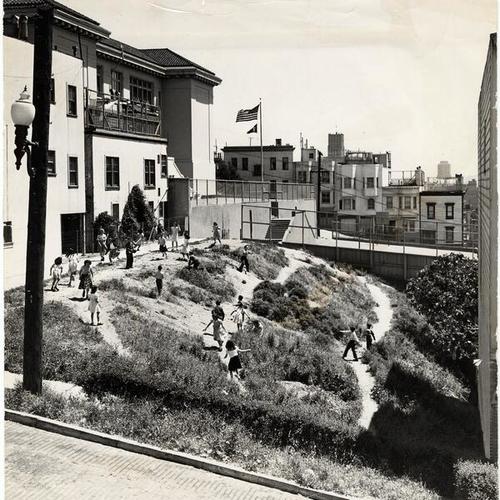 [Children playing in a vacant lot next to Garfield School]