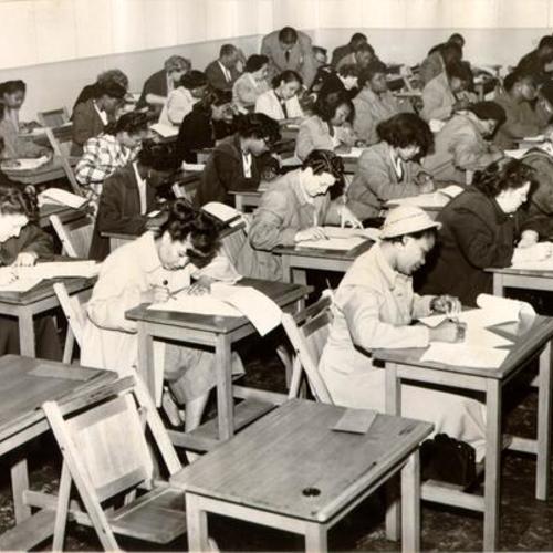[Group of people taking a Civil Service Commission examination]