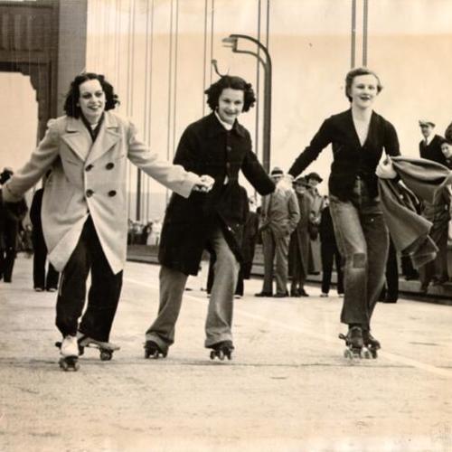 [Three women roller skating across the Golden Gate Bridge on Pedestrian Day]